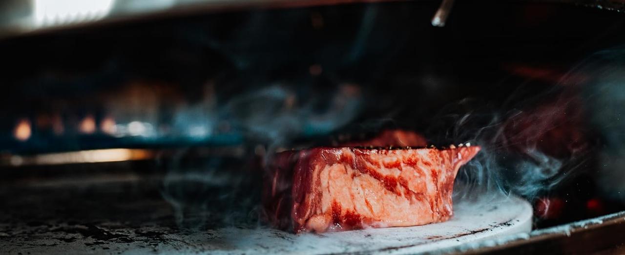 steak on pizza oven