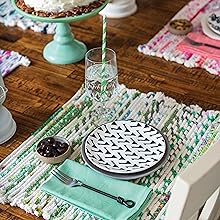 Fabric Wrapped Placemat on a wooden table with plates, silverware, napkins, and other settings.