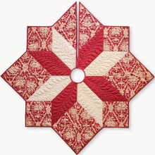 A red and white quilt made using acute angles