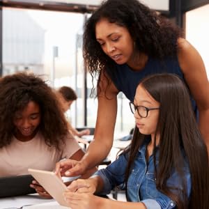 female teacher helping students